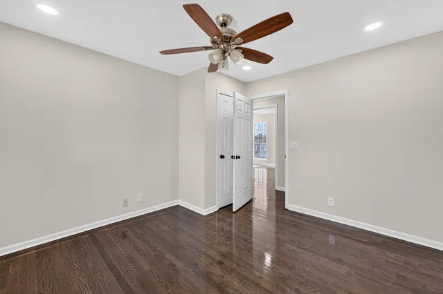 a bathroom with a granite countertop sink a toilet and shower