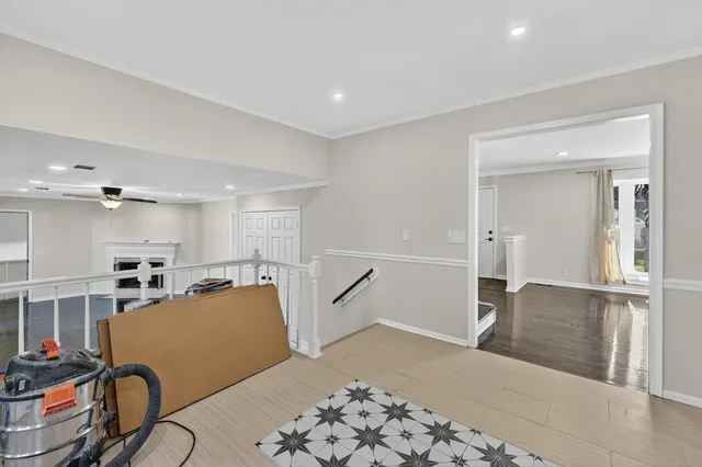 a bedroom with furniture and a large window