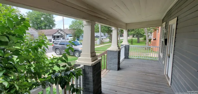 a view of a porch with chairs and backyard