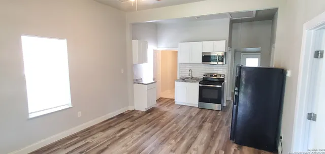 a kitchen with a refrigerator and a stove