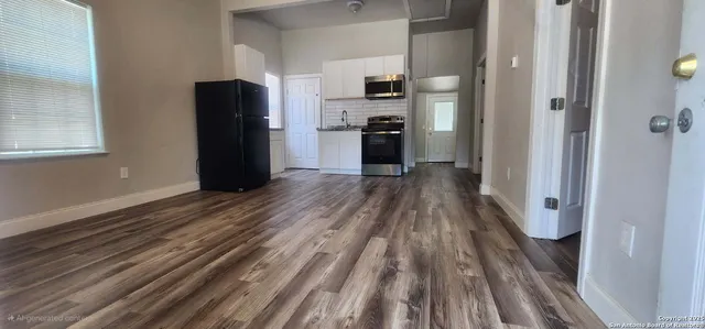 a view of a kitchen from the hallway