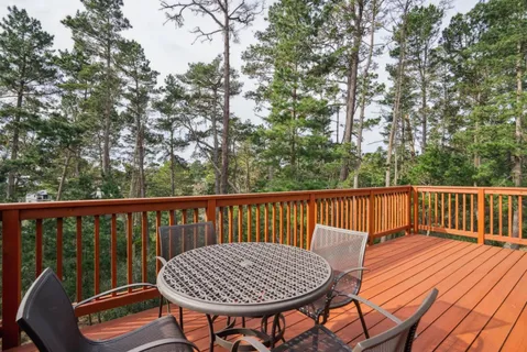 a view of balcony with wooden floor and outdoor seating