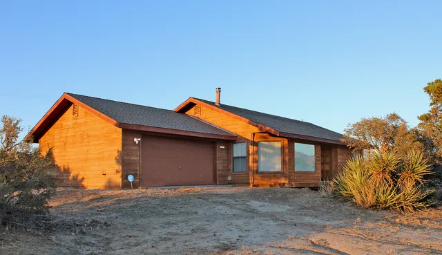 a backyard of a house with wooden fence