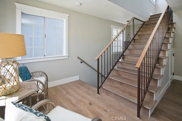 a view of a livingroom with an entryway and wooden floor
