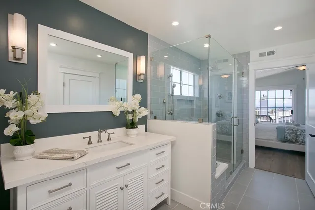 a bathroom with a sink double vanity and shower