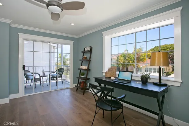 a dining room with furniture a chandelier and wooden floor