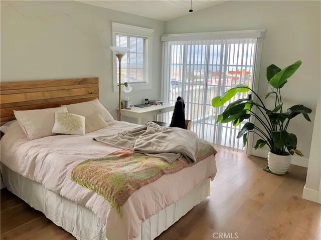 a bedroom with bed and a large window