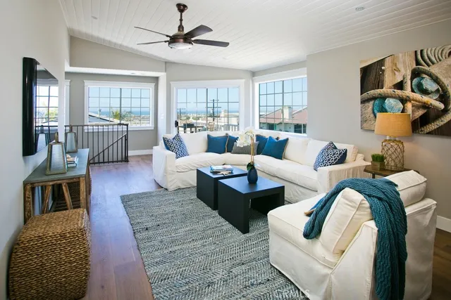 a living room with furniture ceiling fan and a rug