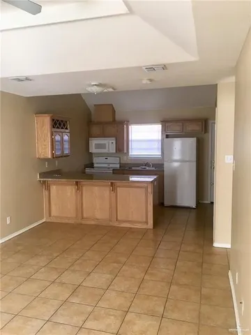 a kitchen with cabinets and window
