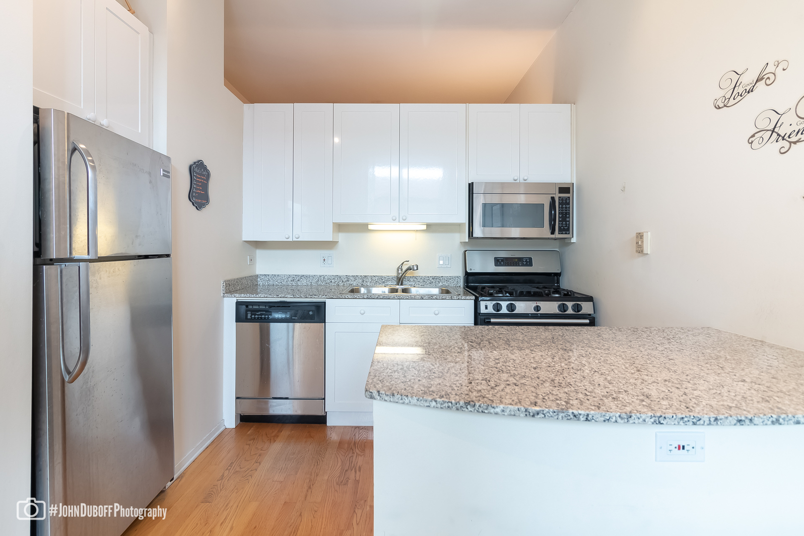 1201 West Adams Street, Unit 809 Chicago, IL 60607 - Photo 4 of 14 a kitchen with granite countertop a refrigerator and a stove top oven