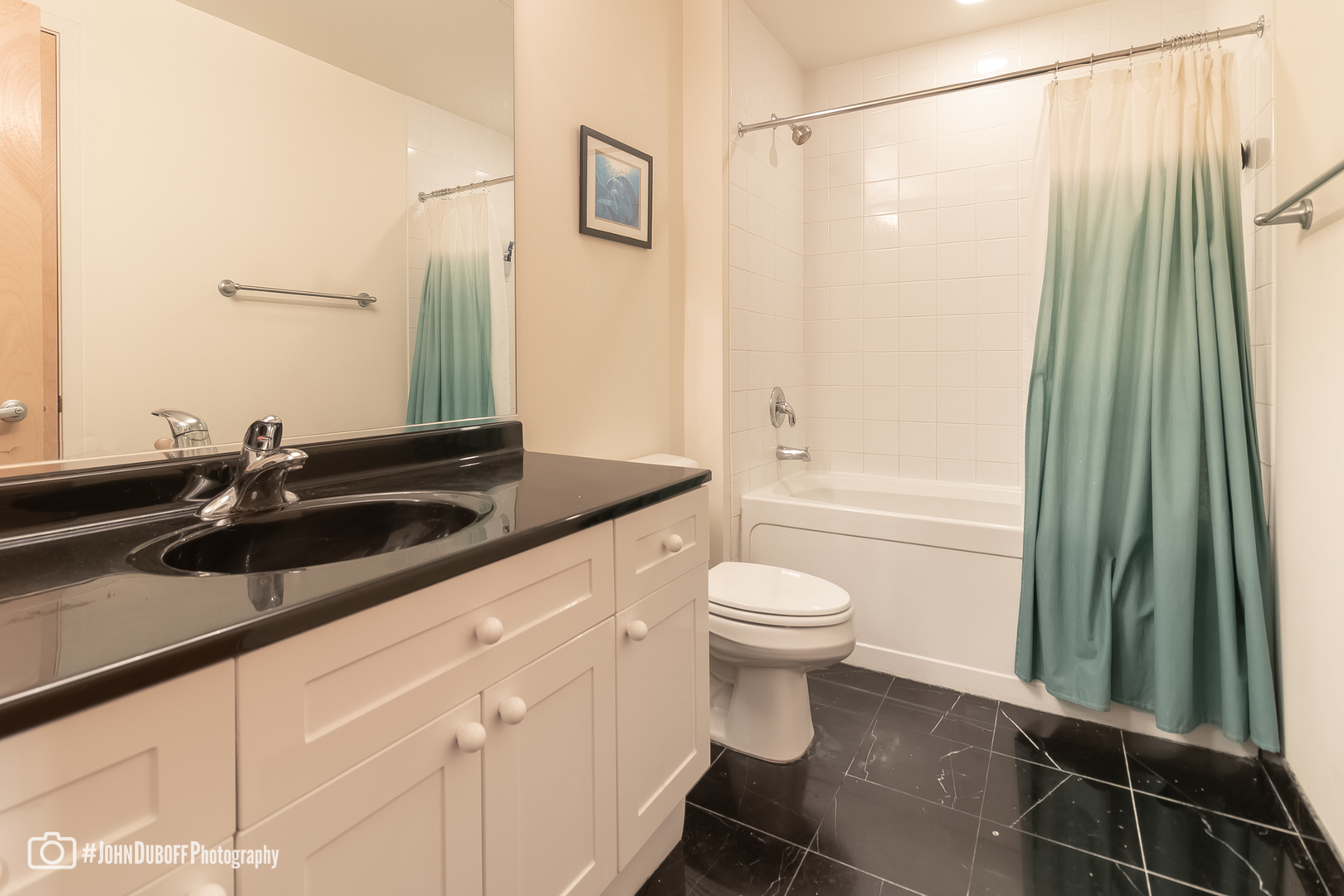1201 West Adams Street, Unit 809 Chicago, IL 60607 - Photo 5 of 14 a bathroom with a sink a toilet a mirror and shower