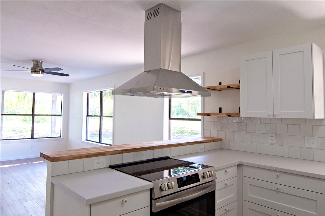 202 Ranch Road Mathis, TX 78368 - Photo 8 of 36 a kitchen with a stove a sink and a window