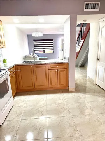 a view of entryway with kitchen