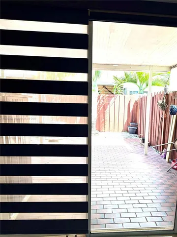 a view of a living room and a floor to ceiling window