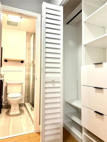 a bathroom with a toilet and a shower