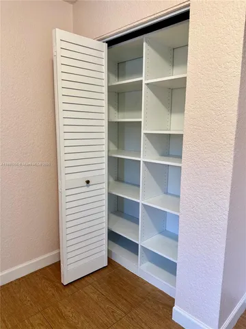 a view of walk in closet with empty racks