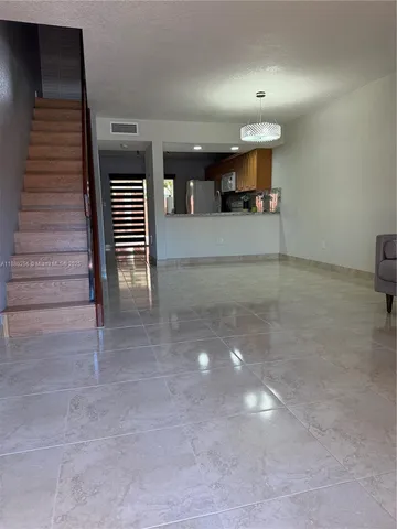 a view of a hallway with stairs