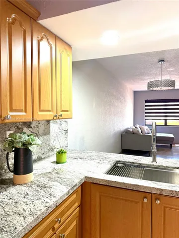 a kitchen with a sink a stove and window