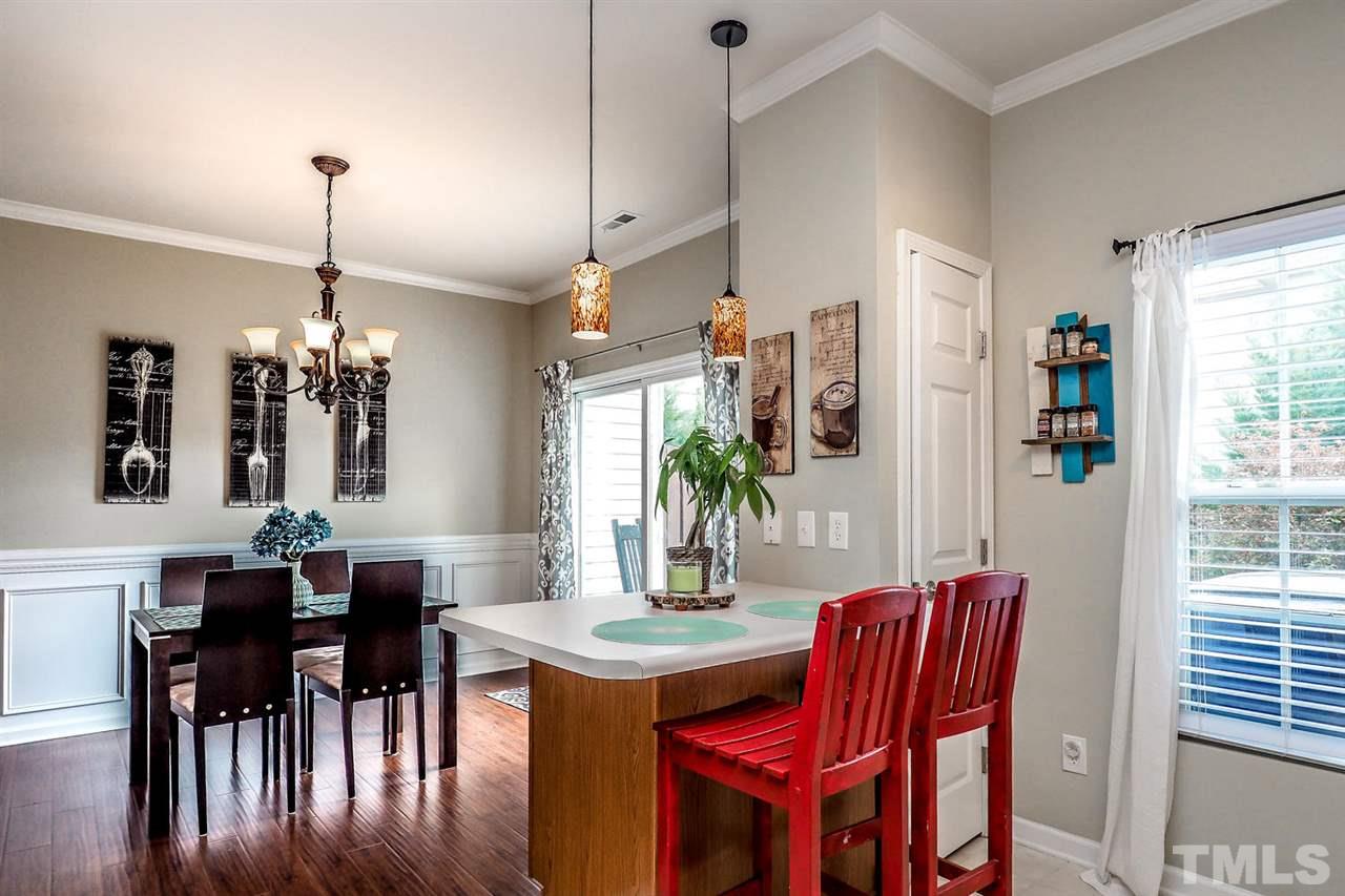 8205 Rhiannon Road Raleigh, NC 27613 - Photo 8 of 23 a dining room with furniture window and wooden floor