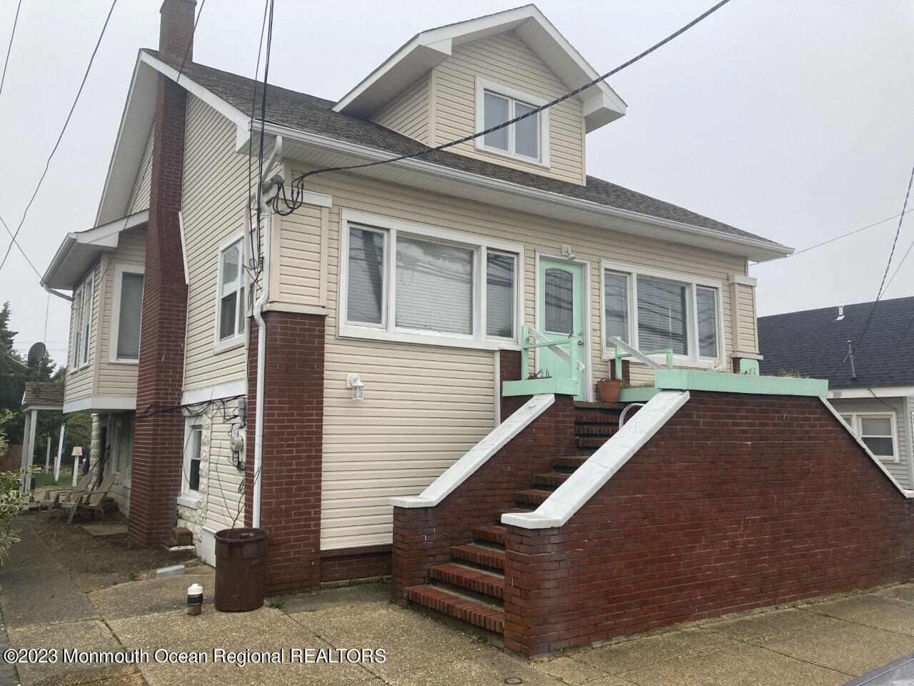 1805 Ocean Boulevard Seaside Park, NJ 08752 - Photo 1 of 6 a front view of a house with a garden