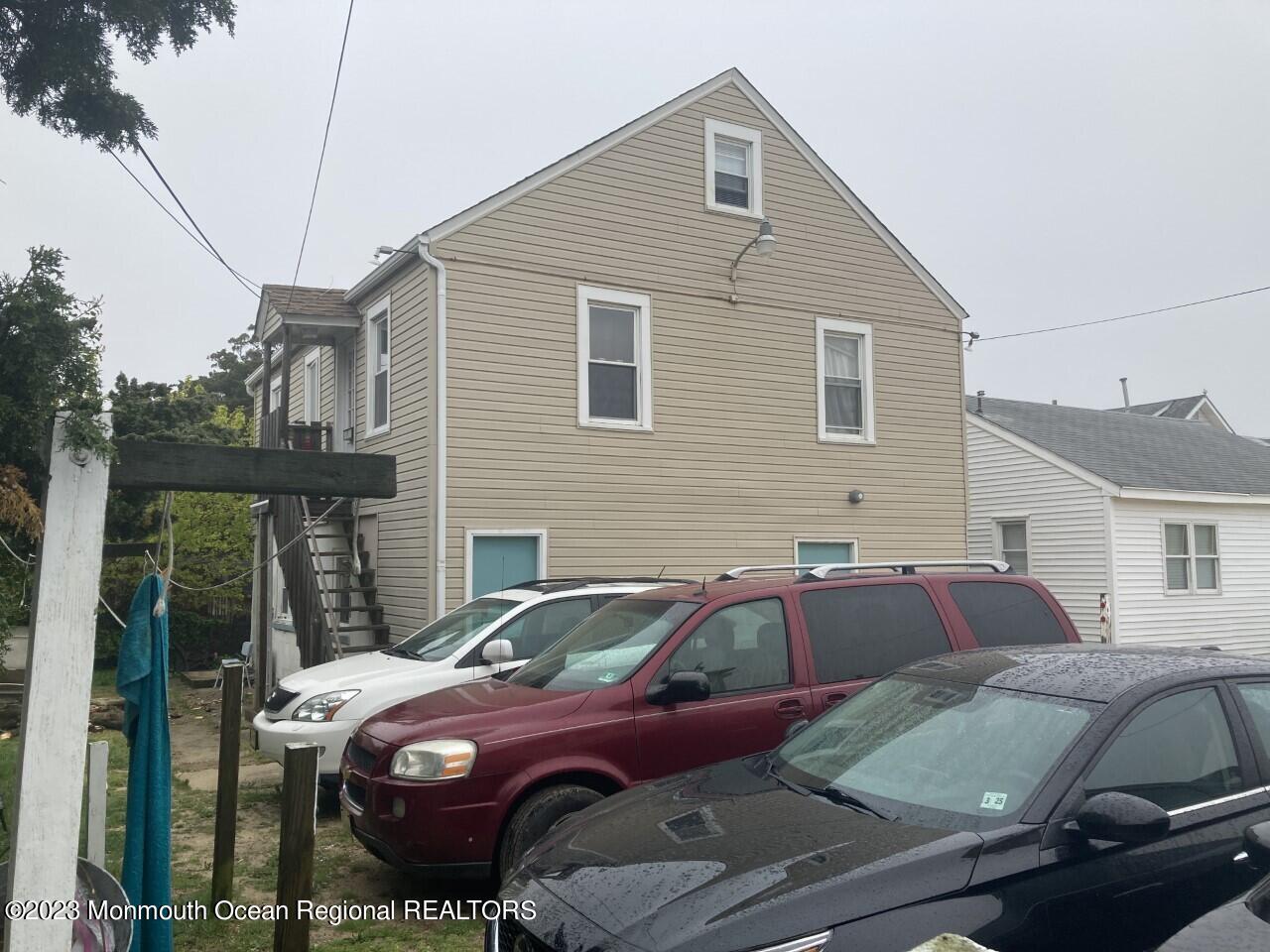 1805 Ocean Boulevard Seaside Park, NJ 08752 - Photo 4 of 6 a front view of a house with cars parked