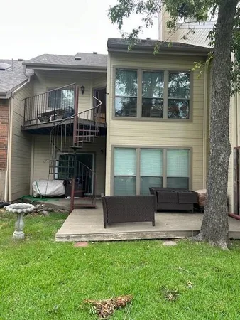 a front view of a house with a garden and plants