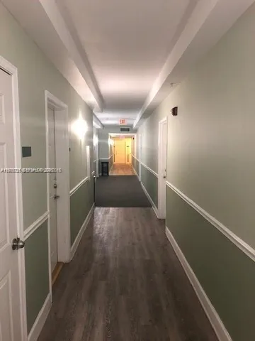 a view of hallway with wooden floor