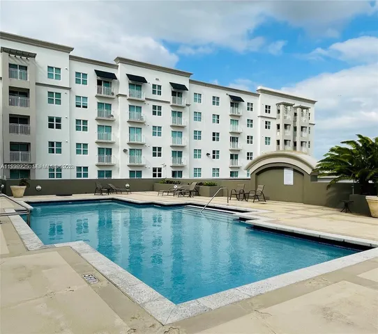 a view of a swimming pool with outdoor seating