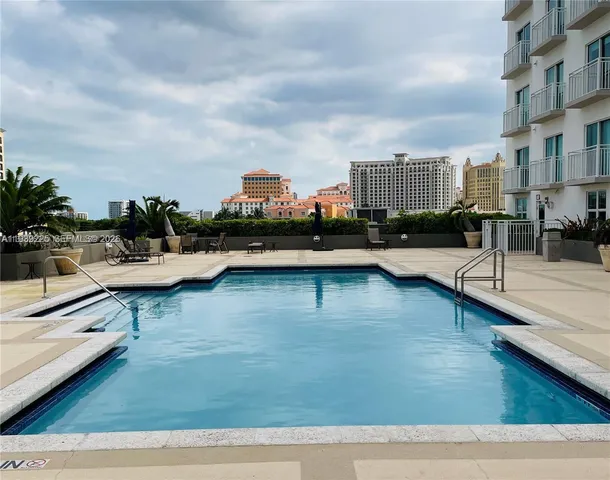 a view of a swimming pool with outdoor seating