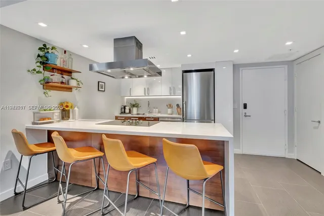a kitchen with kitchen island cabinets and chairs in it