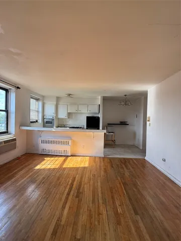 a living room with a couch and next to a window