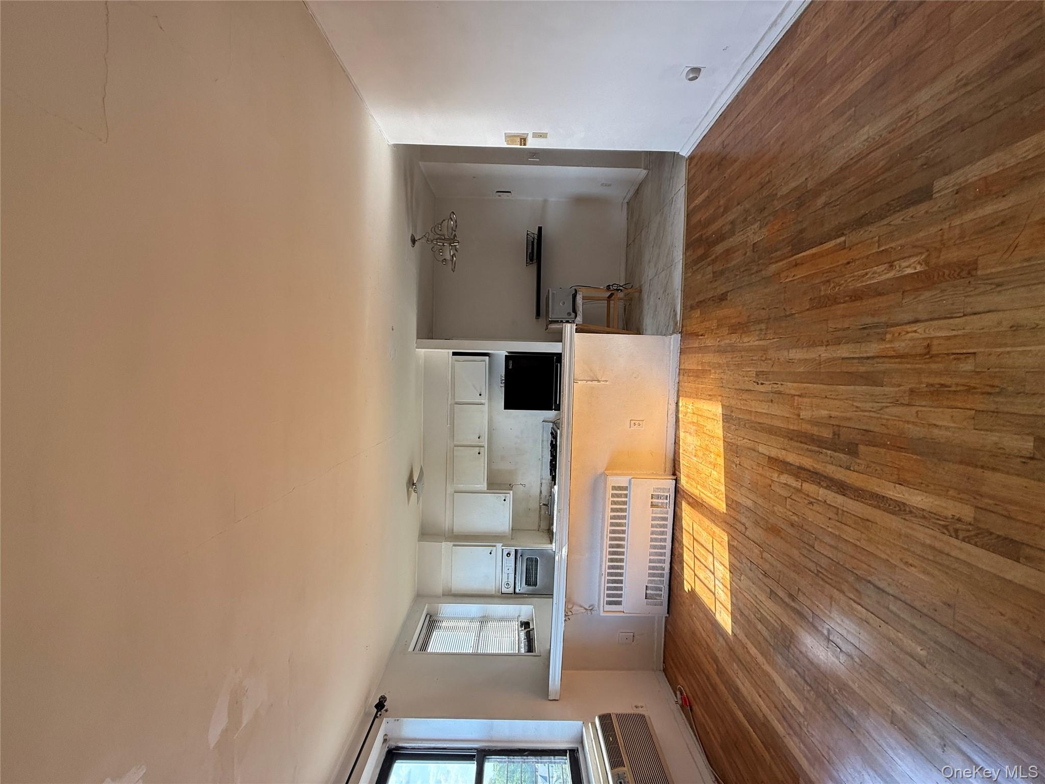 143 Bruce Avenue, Unit 7A Yonkers, NY 10705 - Photo 4 of 8 a living room with a couch and next to a window