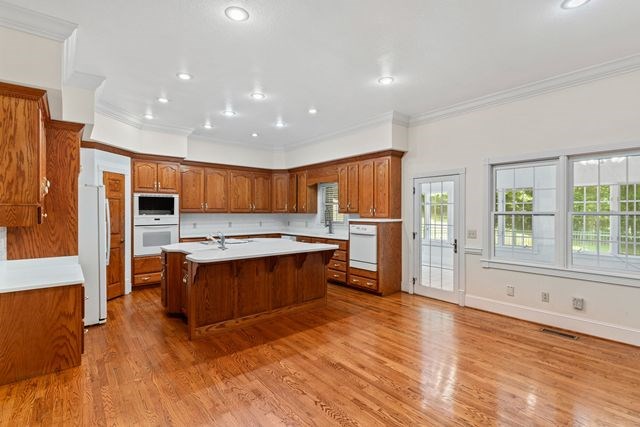 1190 Maple Grove Road Morganton, GA 30560 - Photo 30 of 96 a kitchen with stainless steel appliances granite countertop a refrigerator a sink dishwasher a stove and a dining table with wooden floor
