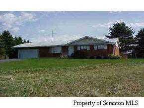 107 Miller Road Clarks Summit, PA 18411 - Photo 1 of 5 a front view of a house with garden
