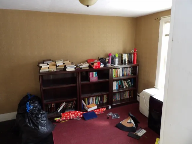 a living room with furniture a flat screen tv and a window