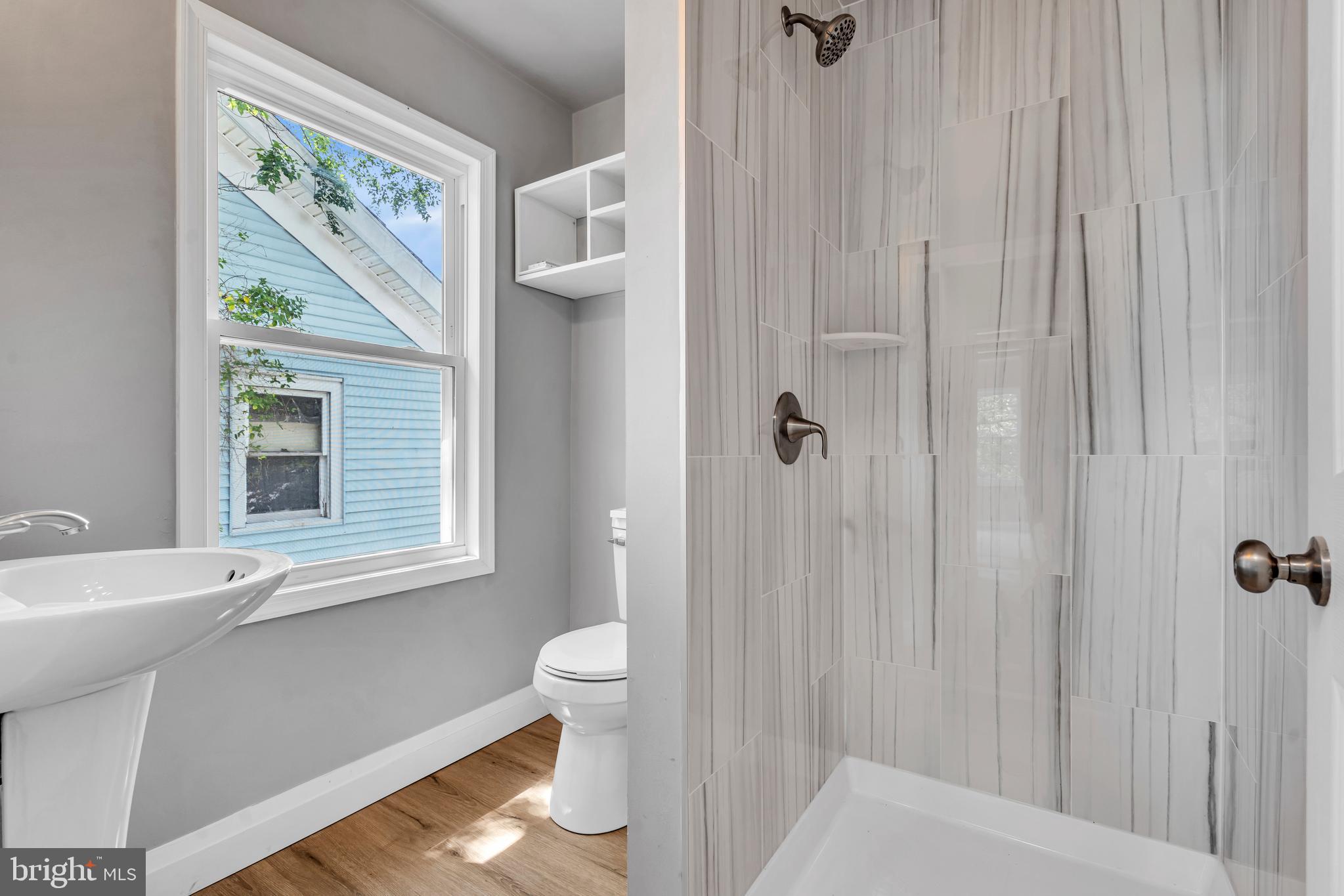 19 East Main Street Salem, NJ 08079 - Photo 21 of 28 a bathroom with a toilet a sink and a window