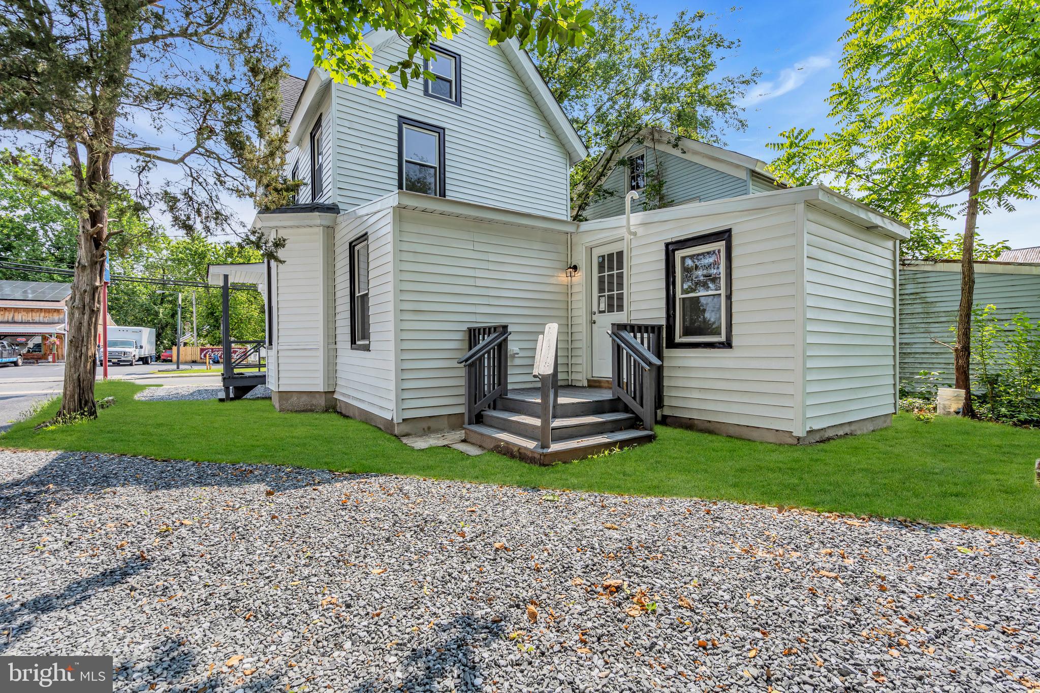 19 East Main Street Salem, NJ 08079 - Photo 28 of 28 a view of a white house with a yard and a large tree