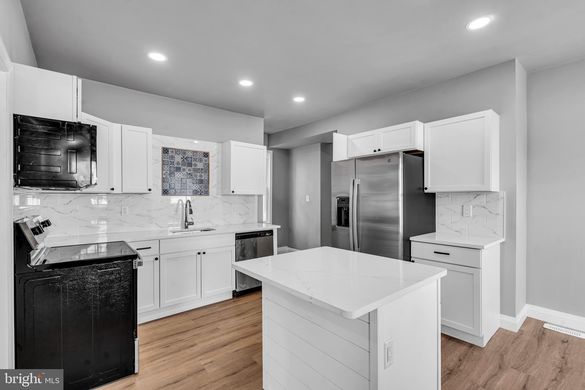 19 East Main Street Salem, NJ 08079 - Photo 7 of 28 a kitchen with a sink stove and refrigerator