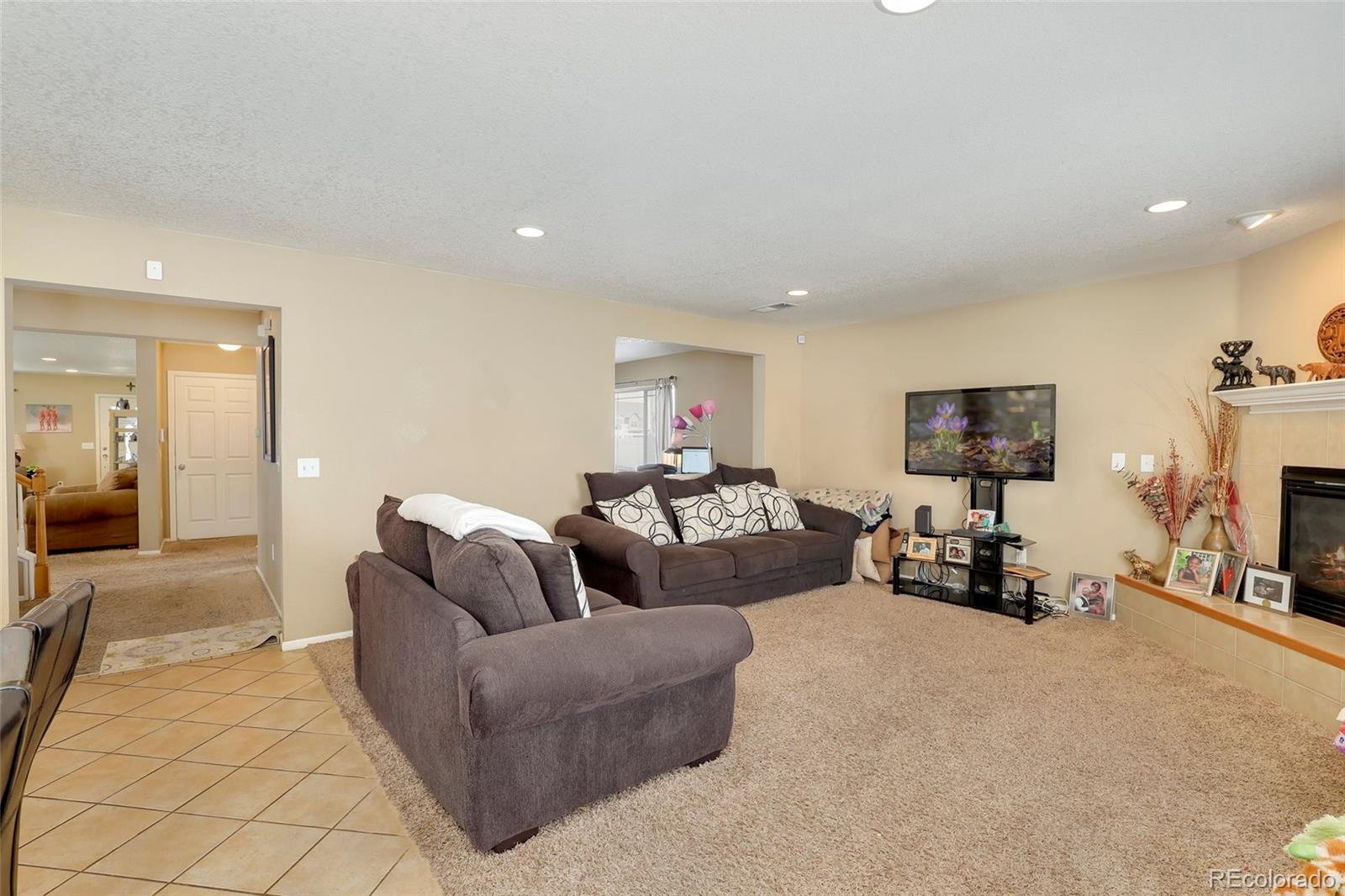 5380 Liverpool Street Denver, CO 80249 - Photo 11 of 30 a living room with furniture and a flat screen tv