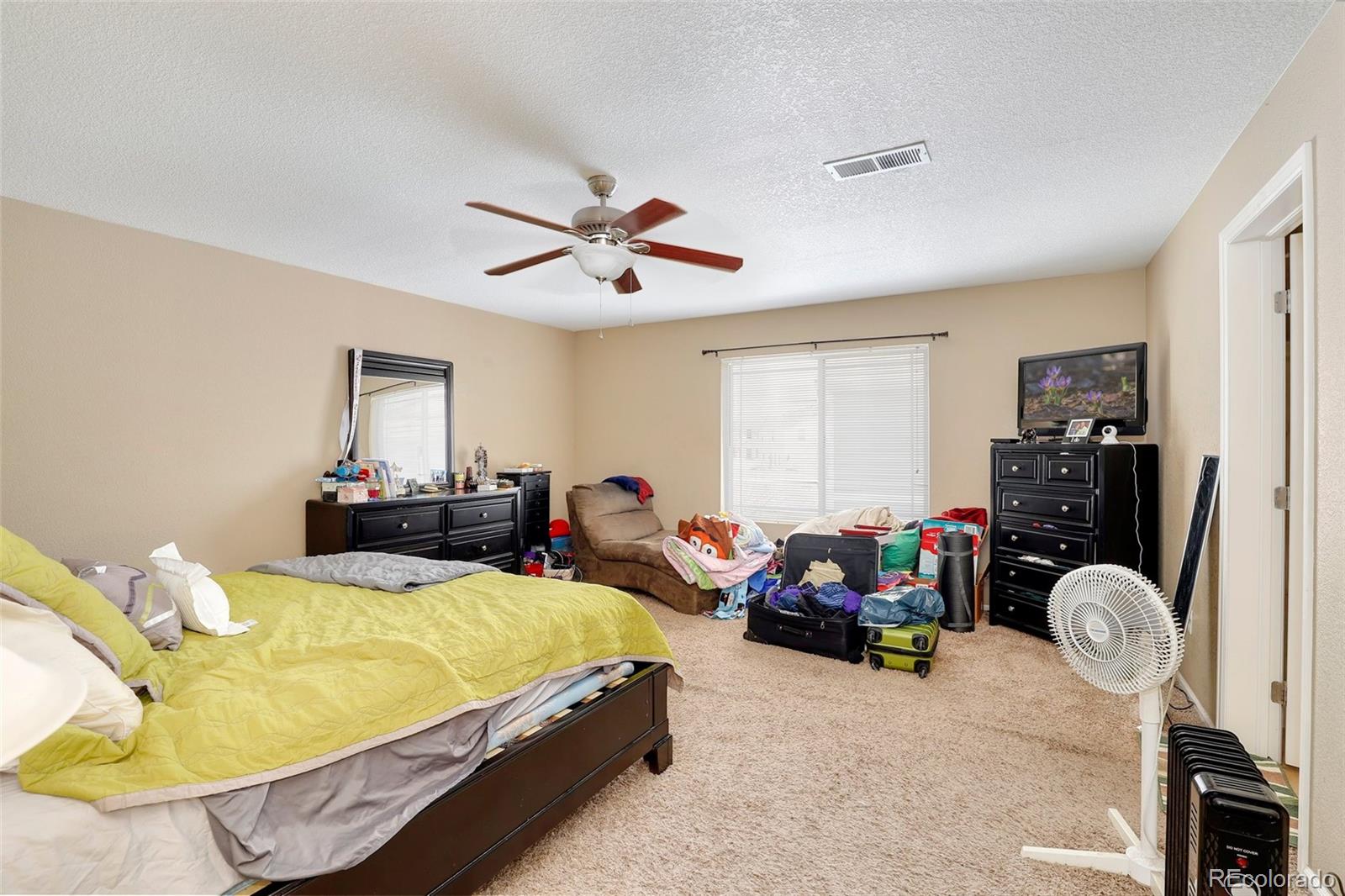5380 Liverpool Street Denver, CO 80249 - Photo 18 of 30 a bed room with two bed and a chair