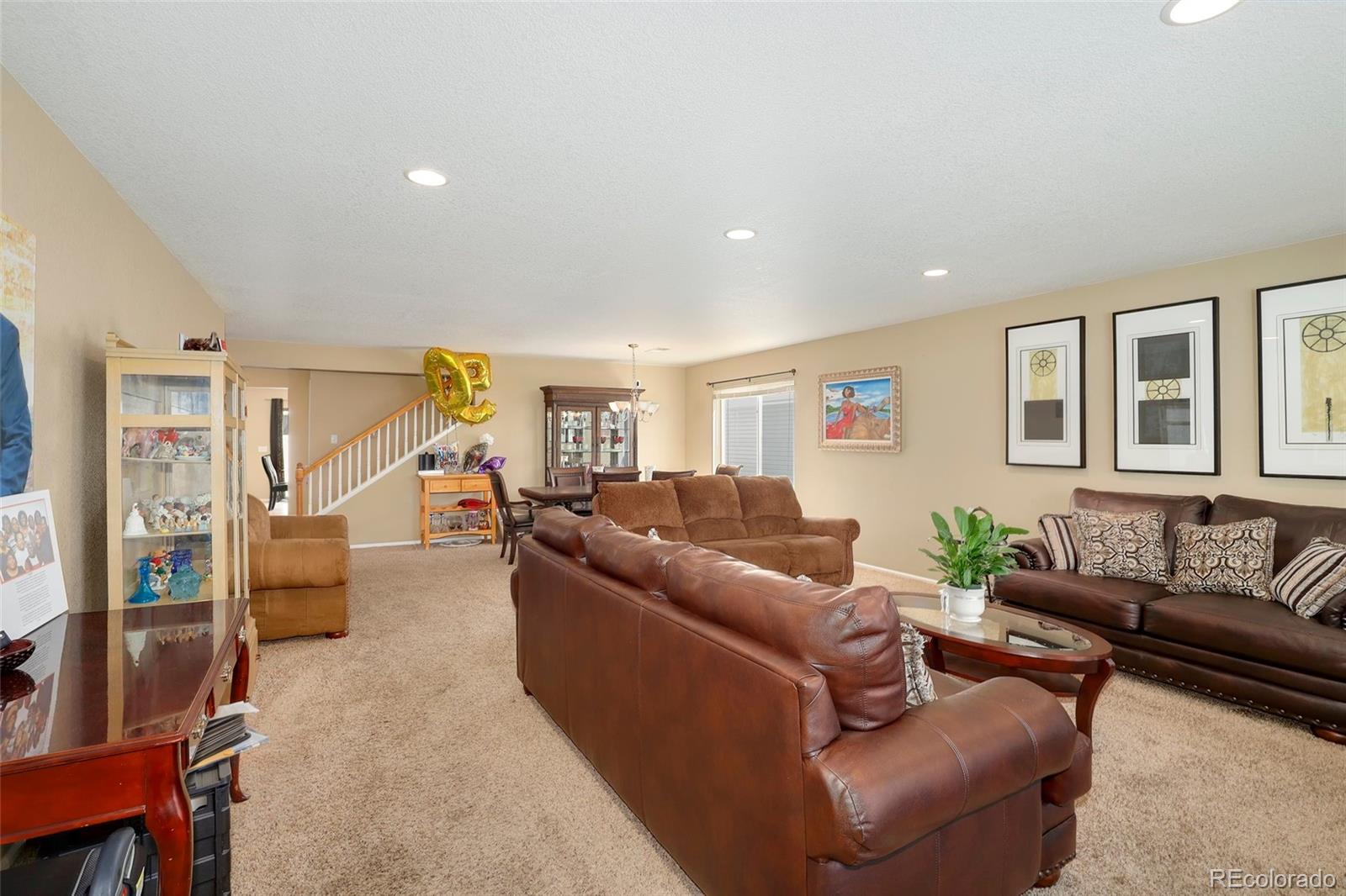 5380 Liverpool Street Denver, CO 80249 - Photo 2 of 30 a living room with furniture and a wooden floor
