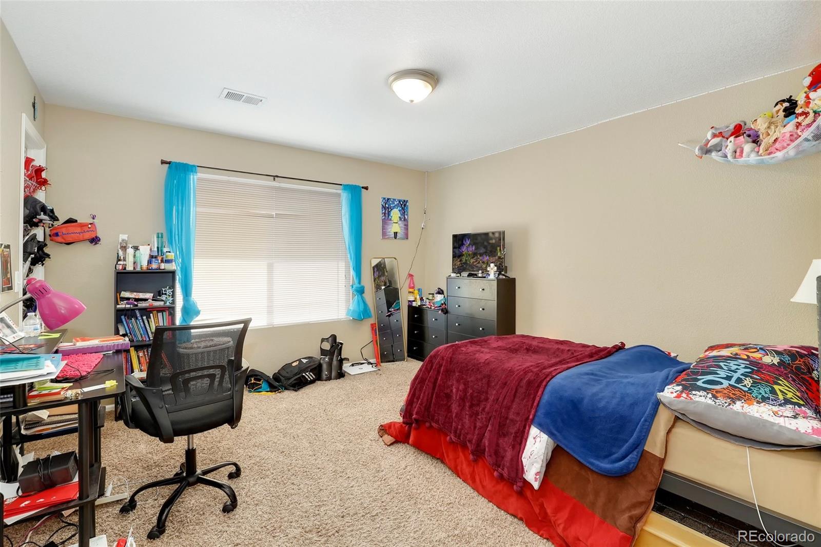 5380 Liverpool Street Denver, CO 80249 - Photo 22 of 30 a bedroom with a bed and furniture