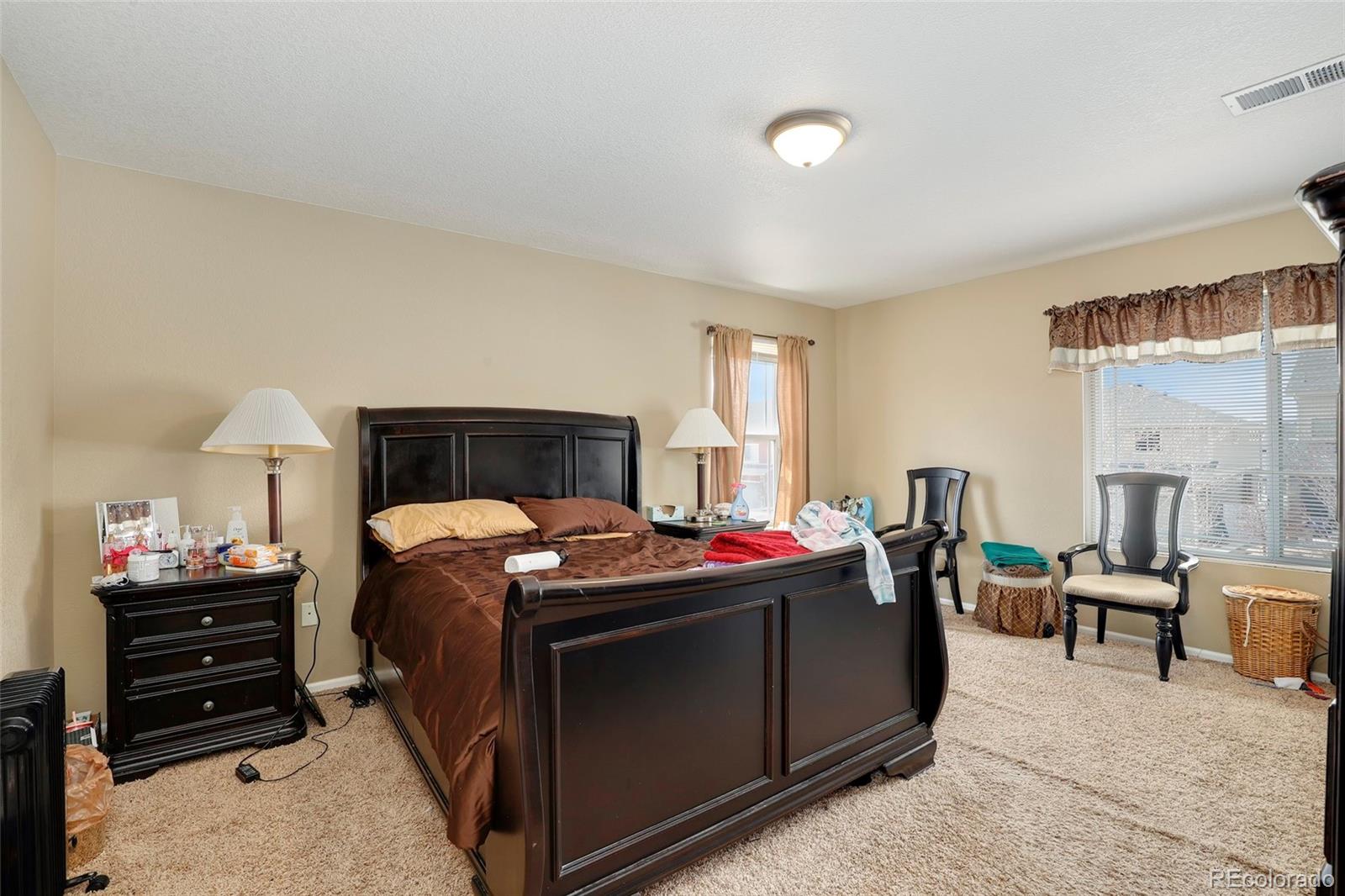 5380 Liverpool Street Denver, CO 80249 - Photo 24 of 30 a bedroom with a bed and a furniture