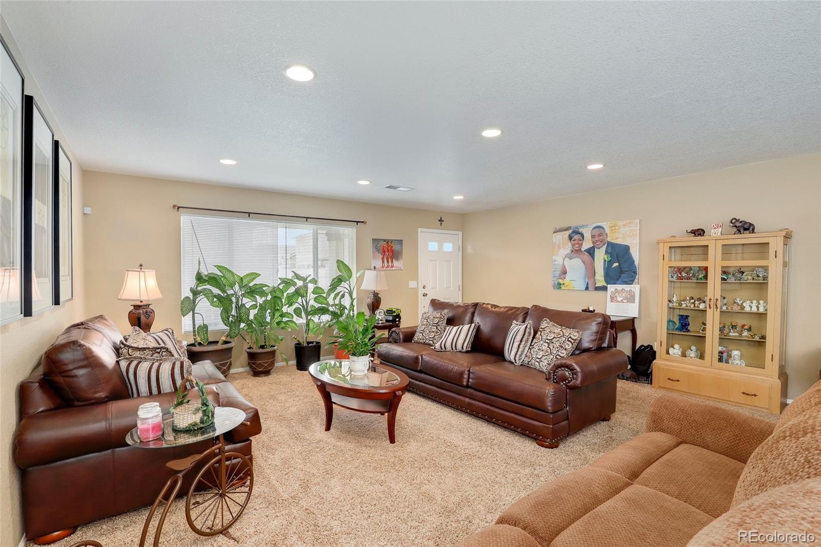 5380 Liverpool Street Denver, CO 80249 - Photo 4 of 30 a living room with furniture and a large window