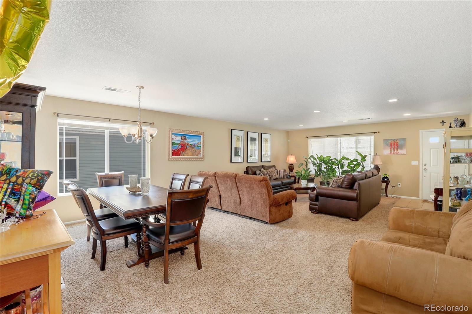5380 Liverpool Street Denver, CO 80249 - Photo 6 of 30 a living room with furniture and a large window
