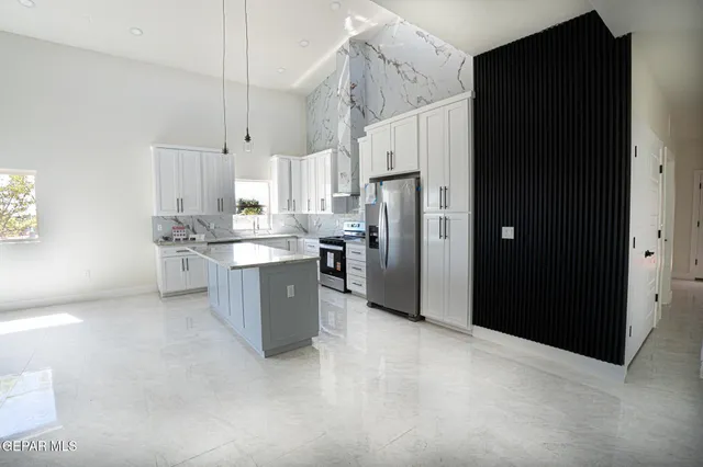 a kitchen with stainless steel appliances a refrigerator sink and cabinets