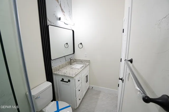 a bathroom with a sink a toilet and mirror