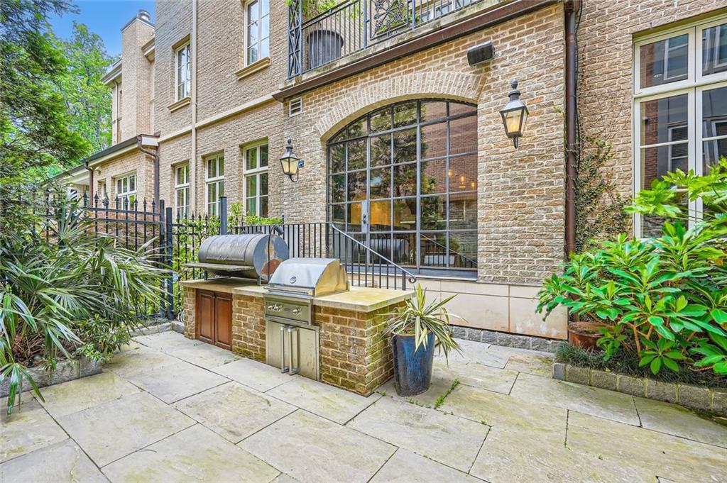 2440 Peachtree Road Northwest, Unit 9 Atlanta, GA 30305 - Photo 14 of 48 a front view of a house with outdoor seating