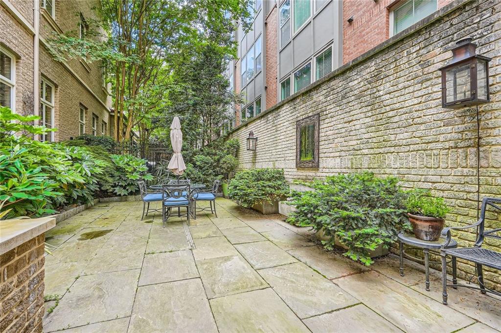 2440 Peachtree Road Northwest, Unit 9 Atlanta, GA 30305 - Photo 15 of 48 a view of a patio with a table and chairs and potted plants