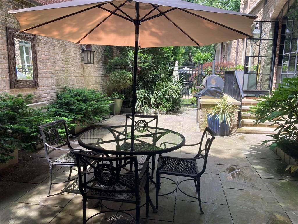 2440 Peachtree Road Northwest, Unit 9 Atlanta, GA 30305 - Photo 18 of 48 a view of an outdoor space with furniture and umbrella